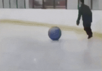 Man on skating rink with ball and children