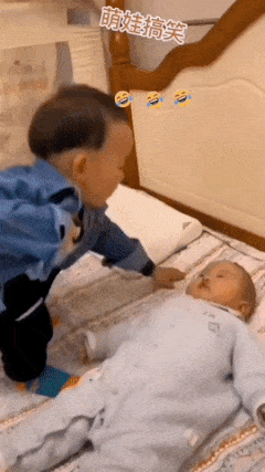Boy feeds baby