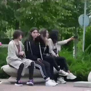 Guy with rose and girls on bench