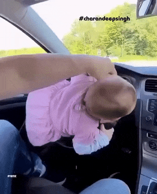 Baby at wheel in car