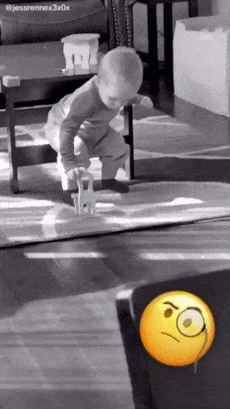 Baby sits on small chair
