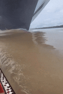 Boat in front of ship