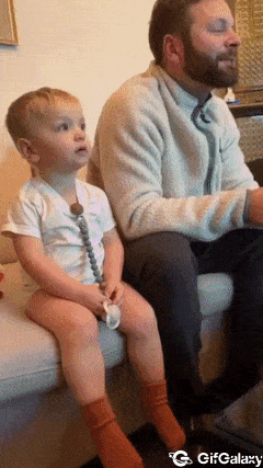 Boy imitates father