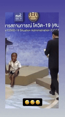 Boy laughs at man on stage