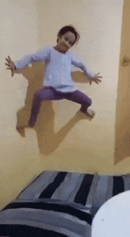 Little girl climbs up the wall