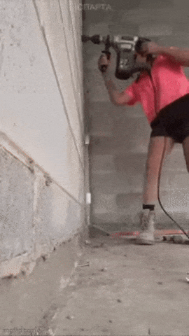 Girl is drilling wall
