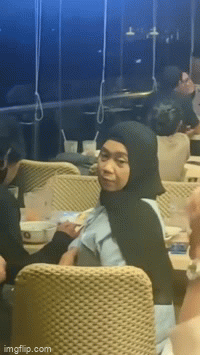 Guy feeds girl in restaurant