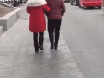 Guy and girl fall on street