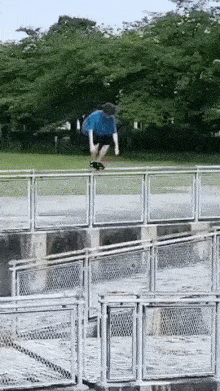 Boy jumping on fence
