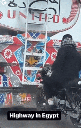 Motorcyclist drives behind truck