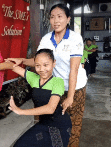 Teacher helping students with choreography