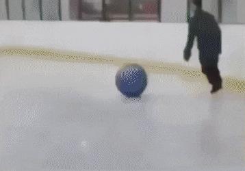 Man on skating rink with ball and children