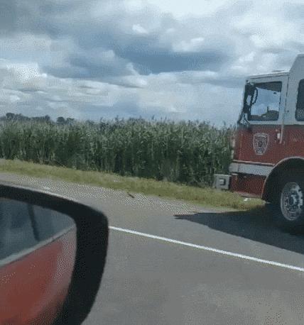Batman on road and firefighters