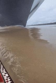 Boat in front of ship