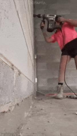 Girl is drilling wall