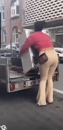 Girl carries refrigerator
