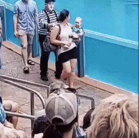 Mother carries baby and backpack