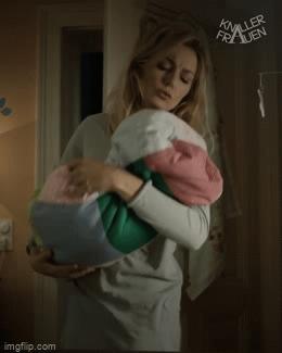 Mother carries baby in her arms