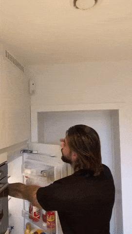 Father closes fridge and child